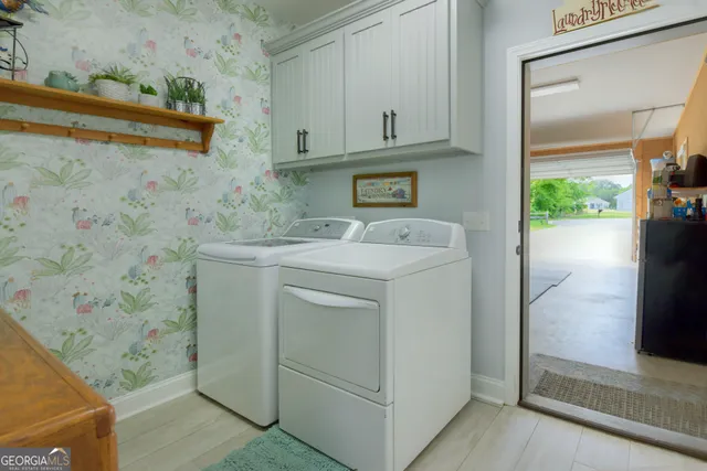 a utility room with a sink a washer and dryer