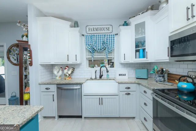 a kitchen with stainless steel appliances a sink stove and cabinets