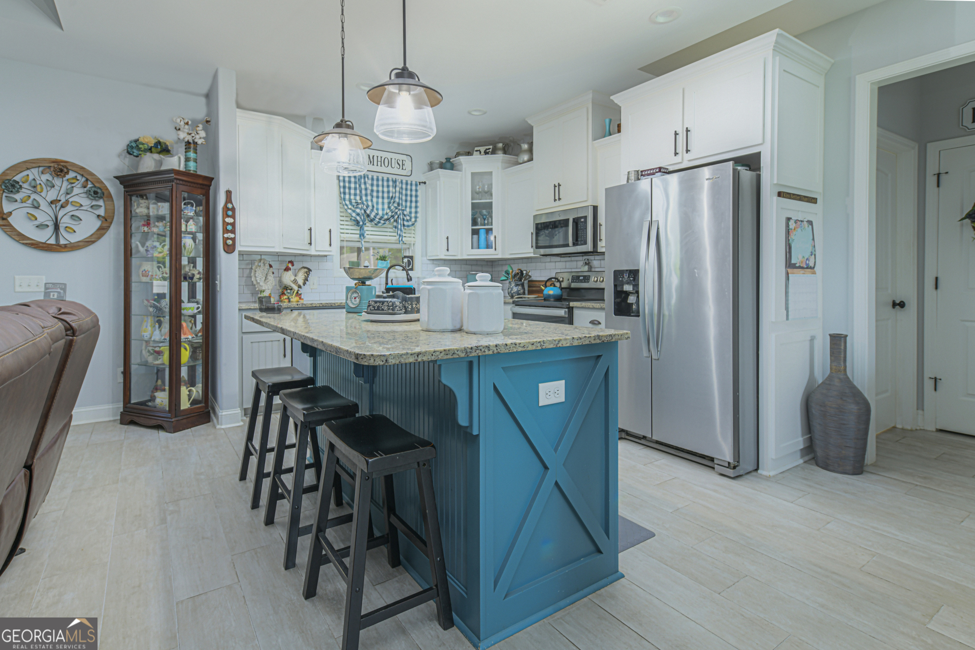 107 Elmo H Circle St. Marys, GA 31558 - Photo 9 of 31 a kitchen with stainless steel appliances a table chairs refrigerator and a fireplace