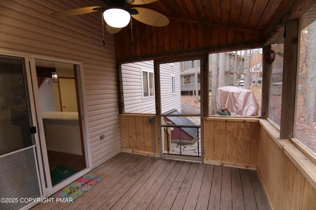 a view of an entryway with wooden floor and door
