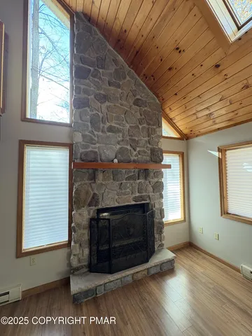 a living room with a fireplace wooden floor and a fireplace