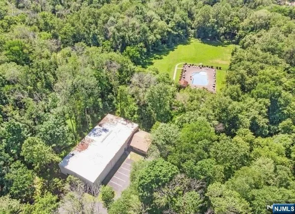 an aerial view of a house with a yard and outdoor seating