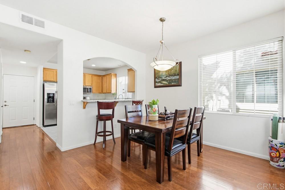 4002 Craven Road, Unit 4 Oceanside, CA 92057 - Photo 14 of 37 a view of a dining room with furniture window and wooden floor