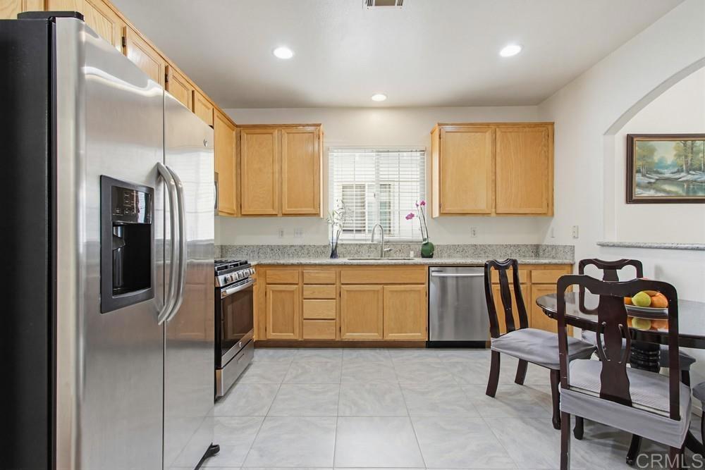 4002 Craven Road, Unit 4 Oceanside, CA 92057 - Photo 16 of 37 a kitchen with granite countertop a refrigerator and a sink