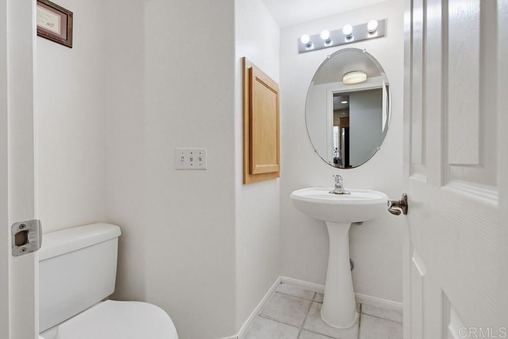 4002 Craven Road, Unit 4 Oceanside, CA 92057 - Photo 18 of 37 a bathroom with a toilet sink and mirror