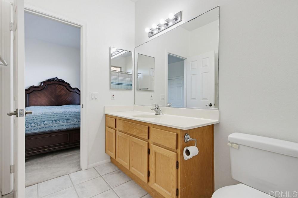 4002 Craven Road, Unit 4 Oceanside, CA 92057 - Photo 24 of 37 a bathroom with a sink a toilet and a mirror