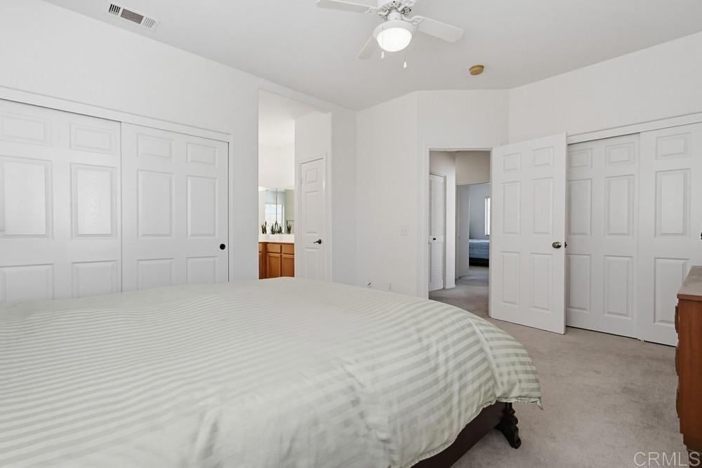 4002 Craven Road, Unit 4 Oceanside, CA 92057 - Photo 29 of 37 a spacious bedroom with a bed and a cabinets