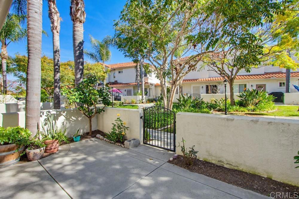 4002 Craven Road, Unit 4 Oceanside, CA 92057 - Photo 7 of 37 a front view of a house with a garden and tree