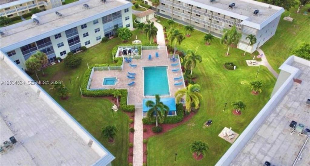 9780 Marina Boulevard, Unit 415 Boca Raton, FL 33428 - Photo 39 of 39 swimming pool view with a garden