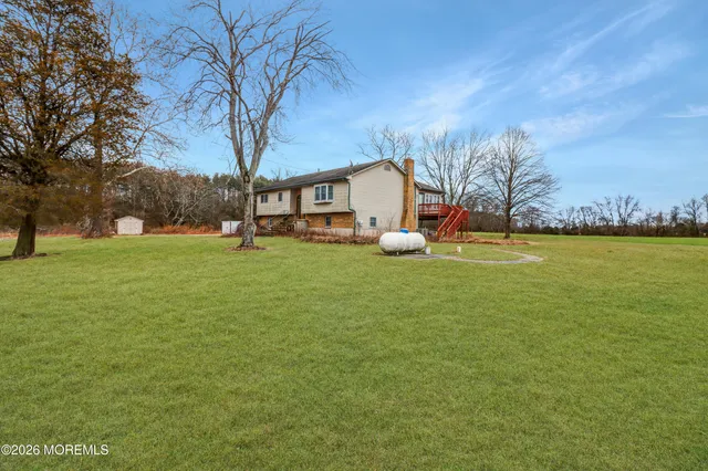 a bathroom with a sink a toilet and a window