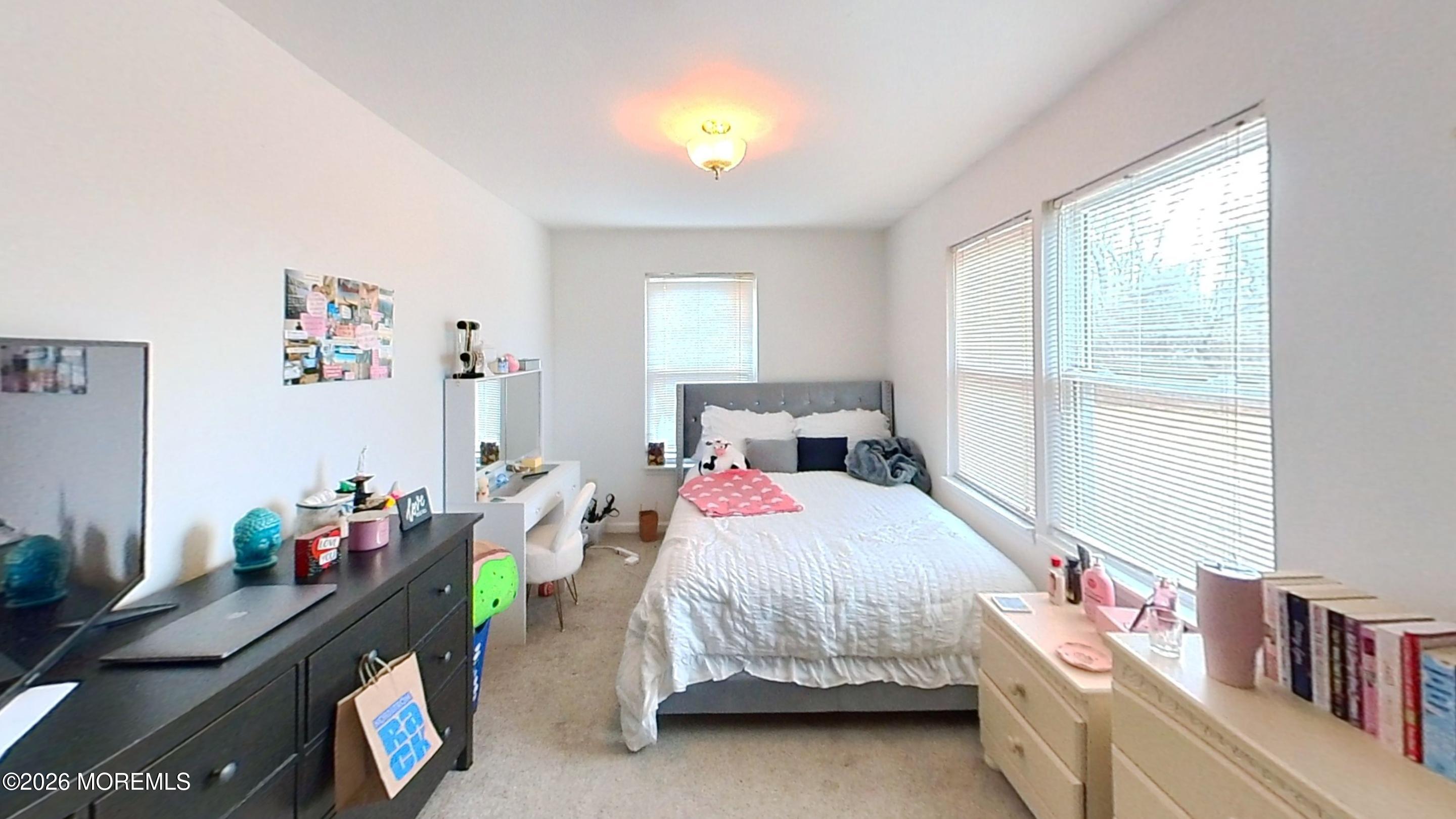 170-174 West Millstream Road Cream Ridge, NJ 08514 - Photo 40 of 105 a bedroom with a bed and a chandelier