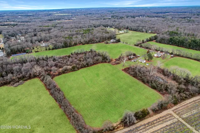 a view of a dining room with furniture a chandelier and wooden floor