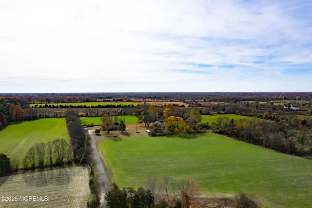 a bedroom with a bed and a flat tv screen on dresser