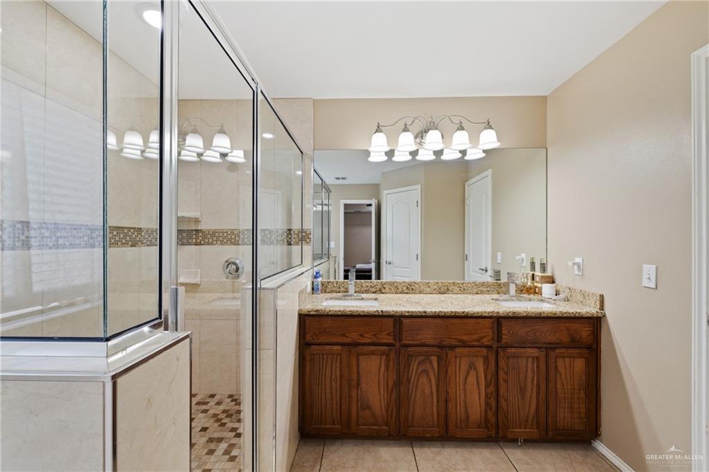9445 Mile 20 Road Edcouch, TX 78538 - Photo 16 of 24 a bathroom with a double vanity sink mirror and shower