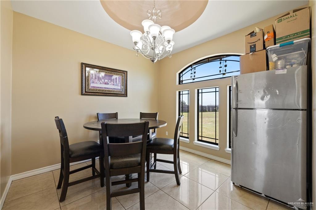 9445 Mile 20 Road Edcouch, TX 78538 - Photo 4 of 24 a view of a dining room with furniture and a chandelier