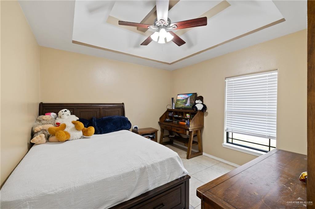 9445 Mile 20 Road Edcouch, TX 78538 - Photo 9 of 24 a bedroom with a bed and wooden floor