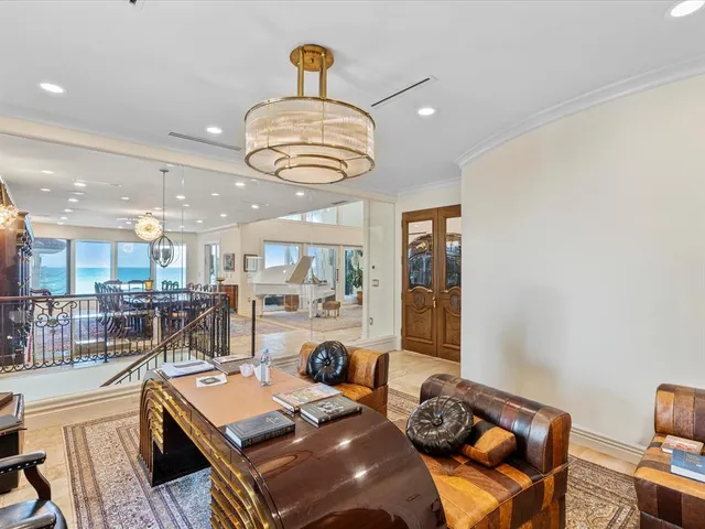 a room with stainless steel appliances furniture a rug and a kitchen view