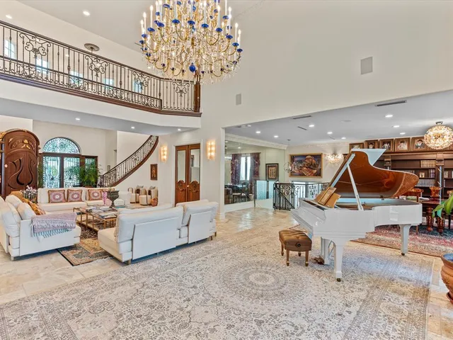 a living room with furniture or chandelier and a wooden floor