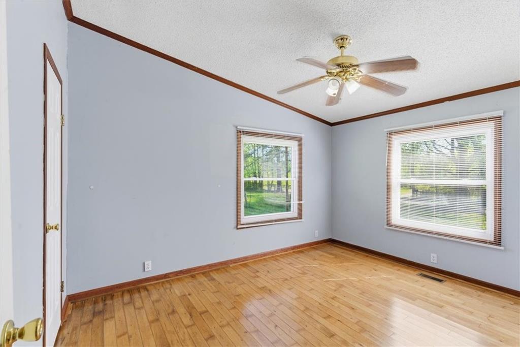 235 Kirk Road Northwest White, GA 30184 - Photo 16 of 41 a view of an empty room with chandelier fan and a window