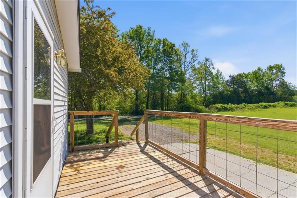 235 Kirk Road Northwest White, GA 30184 - Photo 26 of 41 a view of a balcony with wooden floor and bench