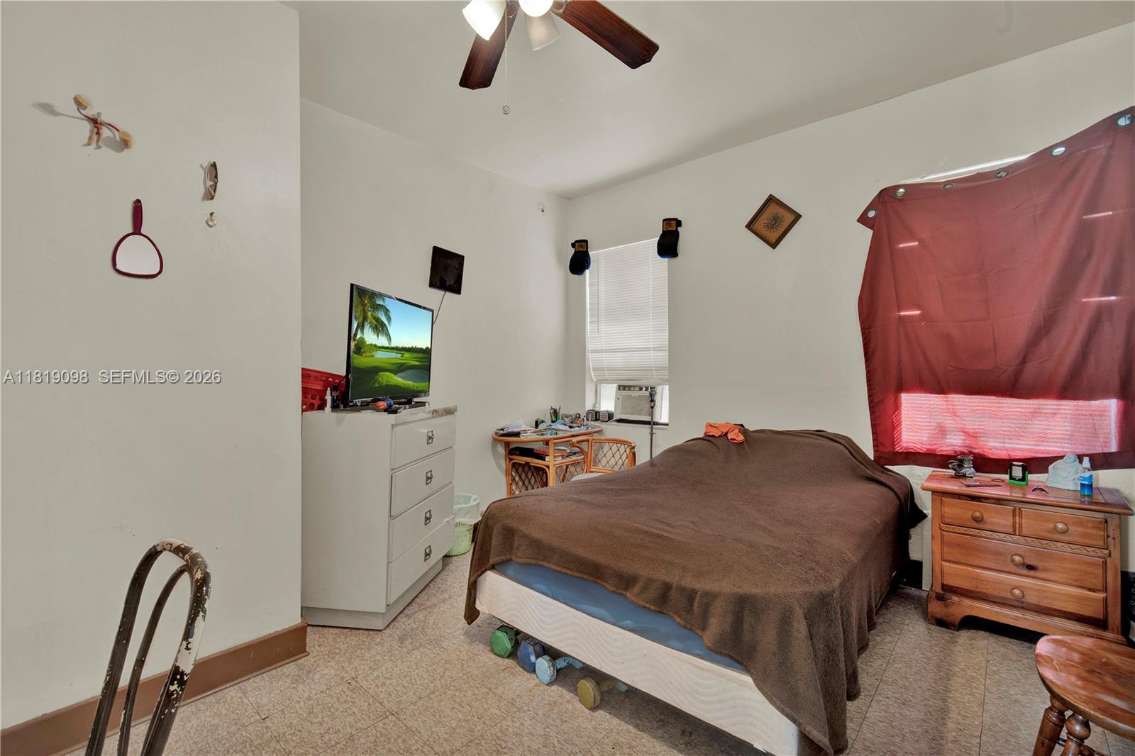 829 Southwest 19th Avenue Miami, FL 33135 - Photo 41 of 54 a bedroom with a bed a couch and a flat tv screen