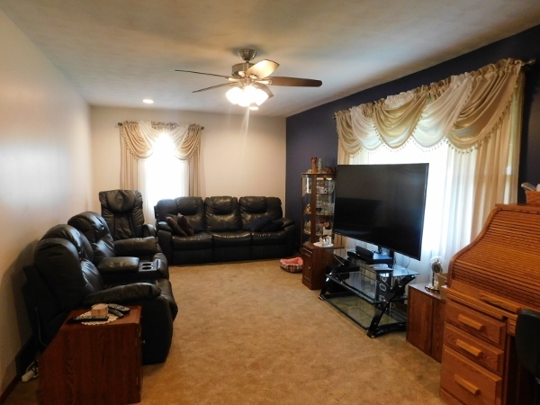 8388 South Brooklyn Road Rochelle, IL 61068 - Photo 12 of 32 a living room with furniture and a flat screen tv
