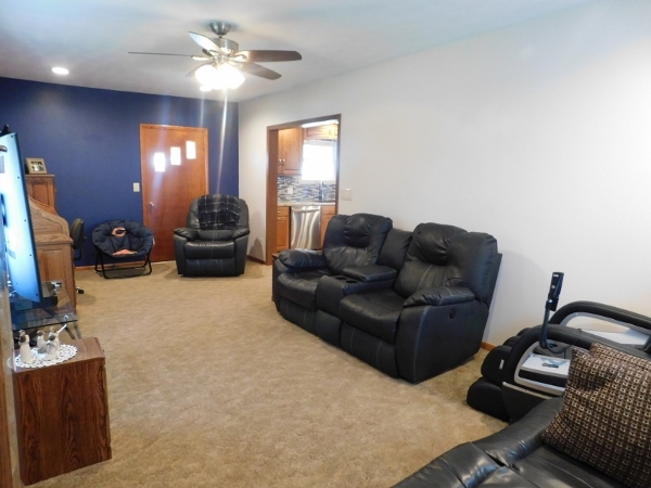 8388 South Brooklyn Road Rochelle, IL 61068 - Photo 13 of 32 a living room with furniture a chandelier and a flat screen tv