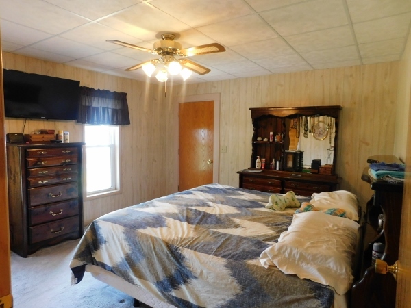 8388 South Brooklyn Road Rochelle, IL 61068 - Photo 15 of 32 a bedroom with a bed and a flat tv screen on the dresser