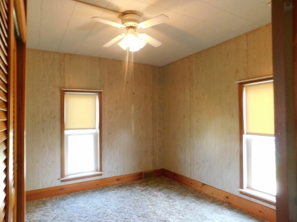 8388 South Brooklyn Road Rochelle, IL 61068 - Photo 19 of 32 an empty room with windows and fan