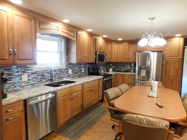 8388 South Brooklyn Road Rochelle, IL 61068 - Photo 8 of 32 a kitchen with stainless steel appliances granite countertop a sink a stove a refrigerator a dining table and chairs