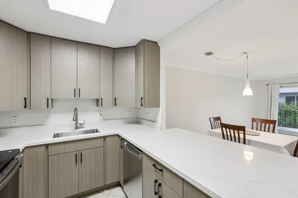 a kitchen with a sink cabinets and window