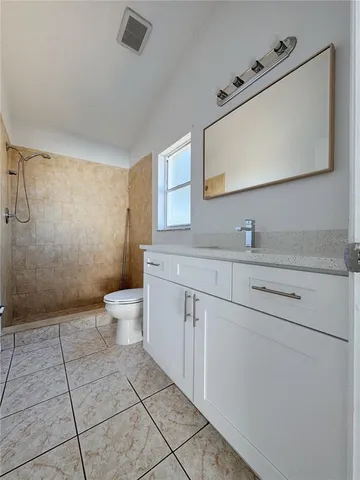 a bathroom with a sink a toilet and mirror