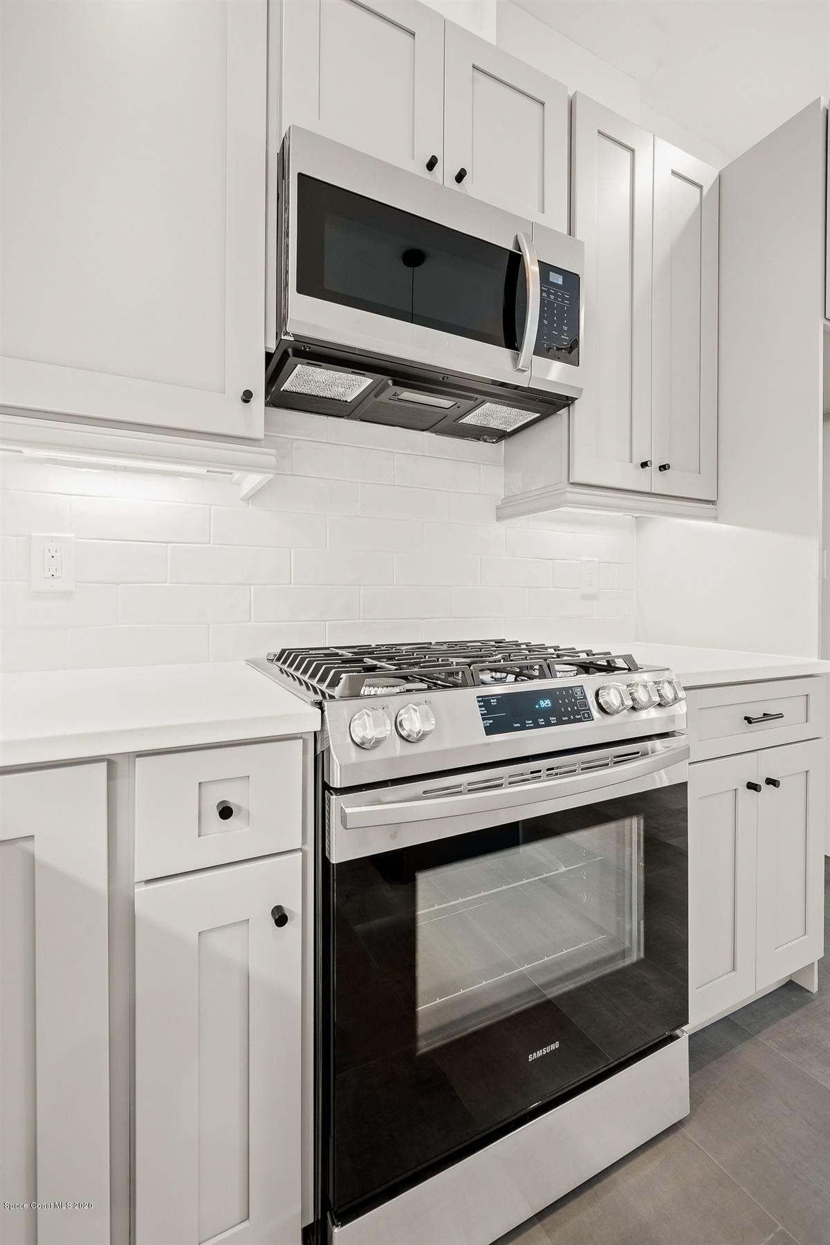 2158 Country Club Road Melbourne, FL 32901 - Photo 20 of 94 a stove top oven sitting inside of a kitchen