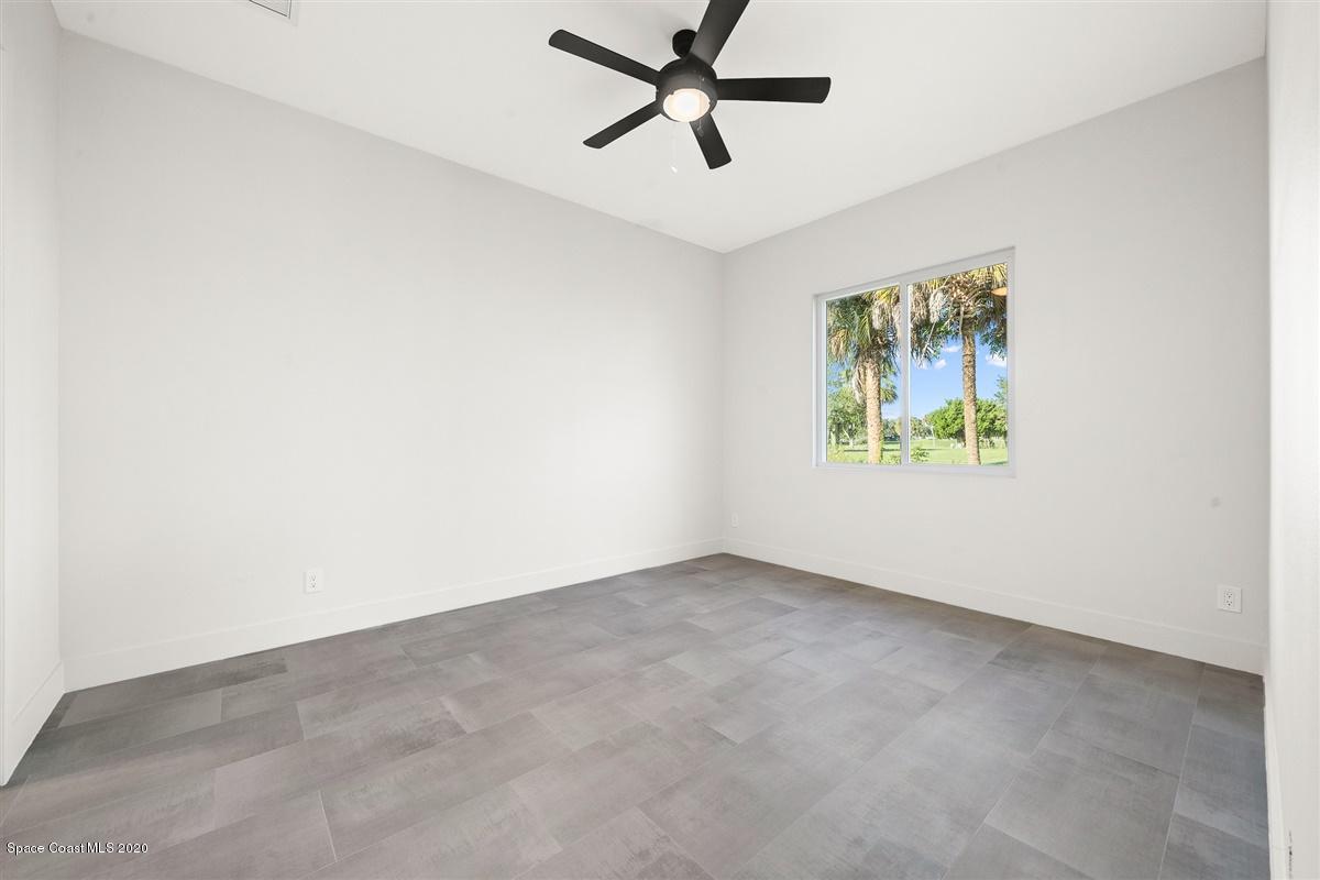 2158 Country Club Road Melbourne, FL 32901 - Photo 26 of 94 an empty room with window and ceiling fan