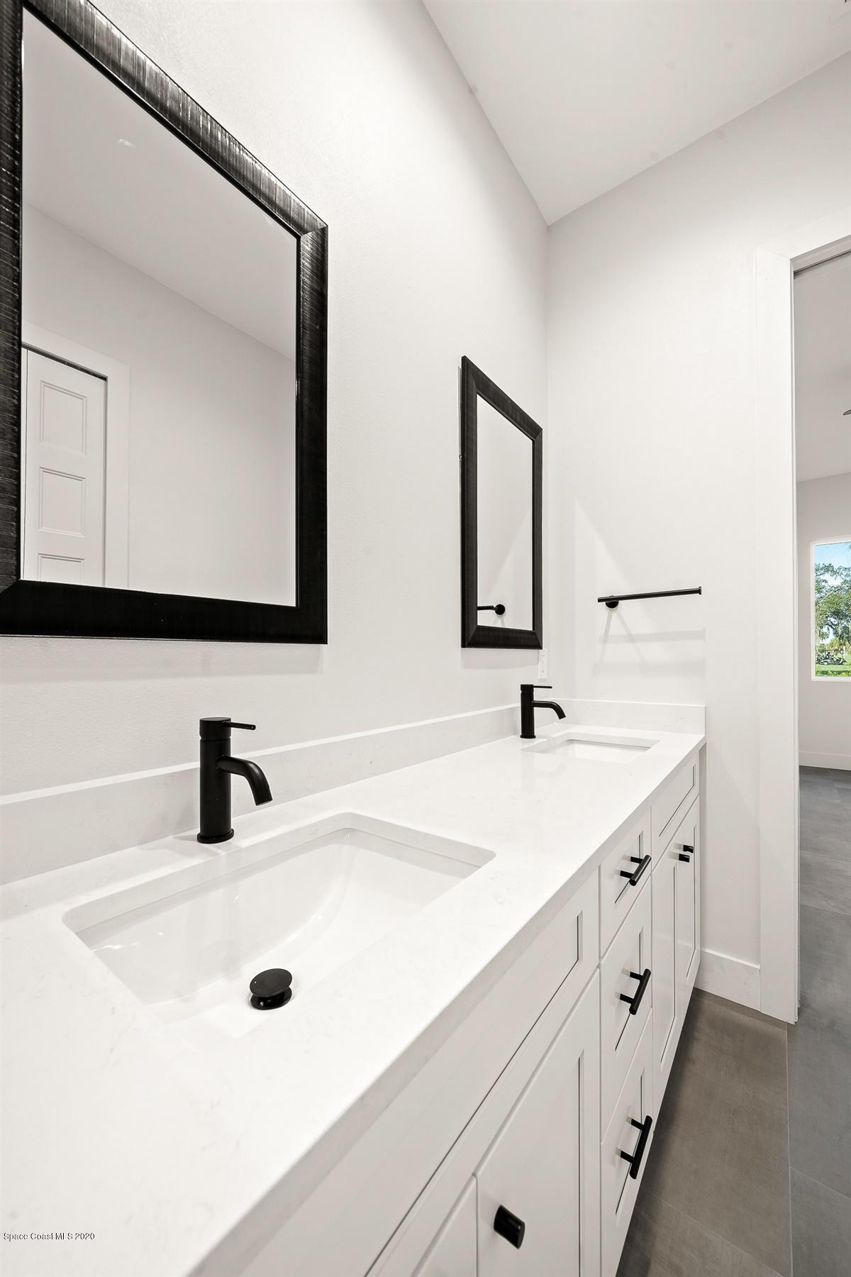 2158 Country Club Road Melbourne, FL 32901 - Photo 32 of 94 a bathroom with a double vanity sink and a mirror