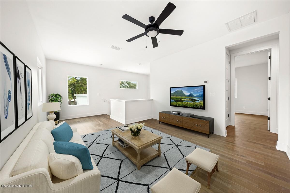 2158 Country Club Road Melbourne, FL 32901 - Photo 38 of 94 a living room with furniture and a wooden floor
