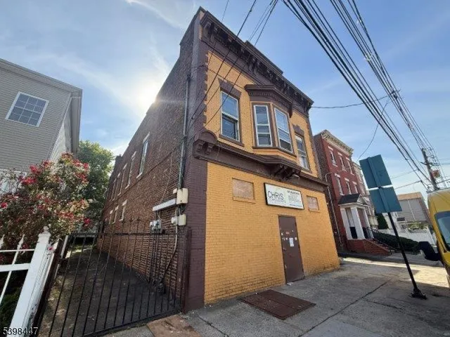 a view of a brick house with many windows