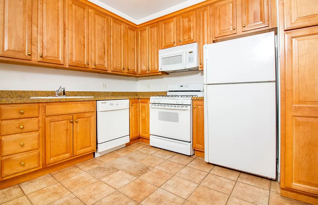 a utility room with granite countertop cabinets washer and dryer