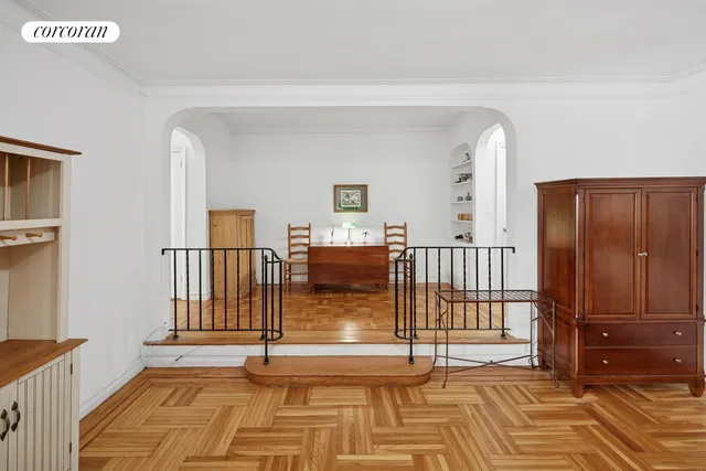 a view of entryway bedroom and hall with wooden floor