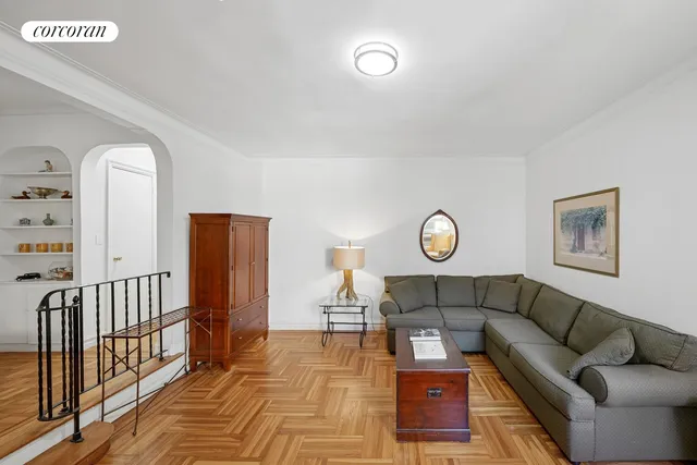 a living room with a couch and a clock