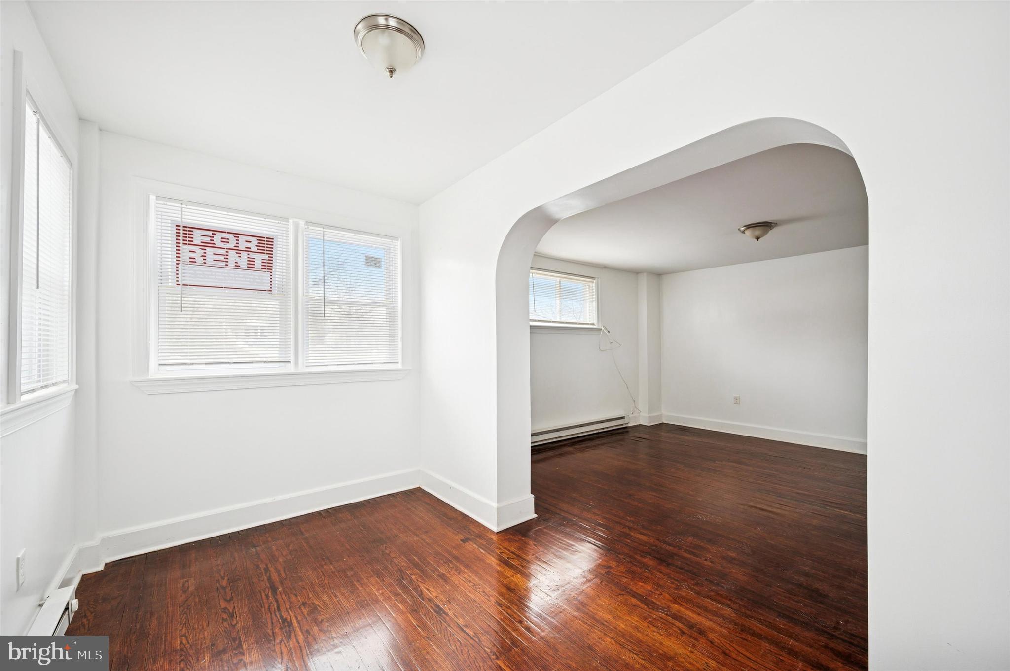 2000 Widener Place, Unit 2 Philadelphia, PA 19138 - Photo 4 of 15 an empty room with wooden floor cabinet and windows