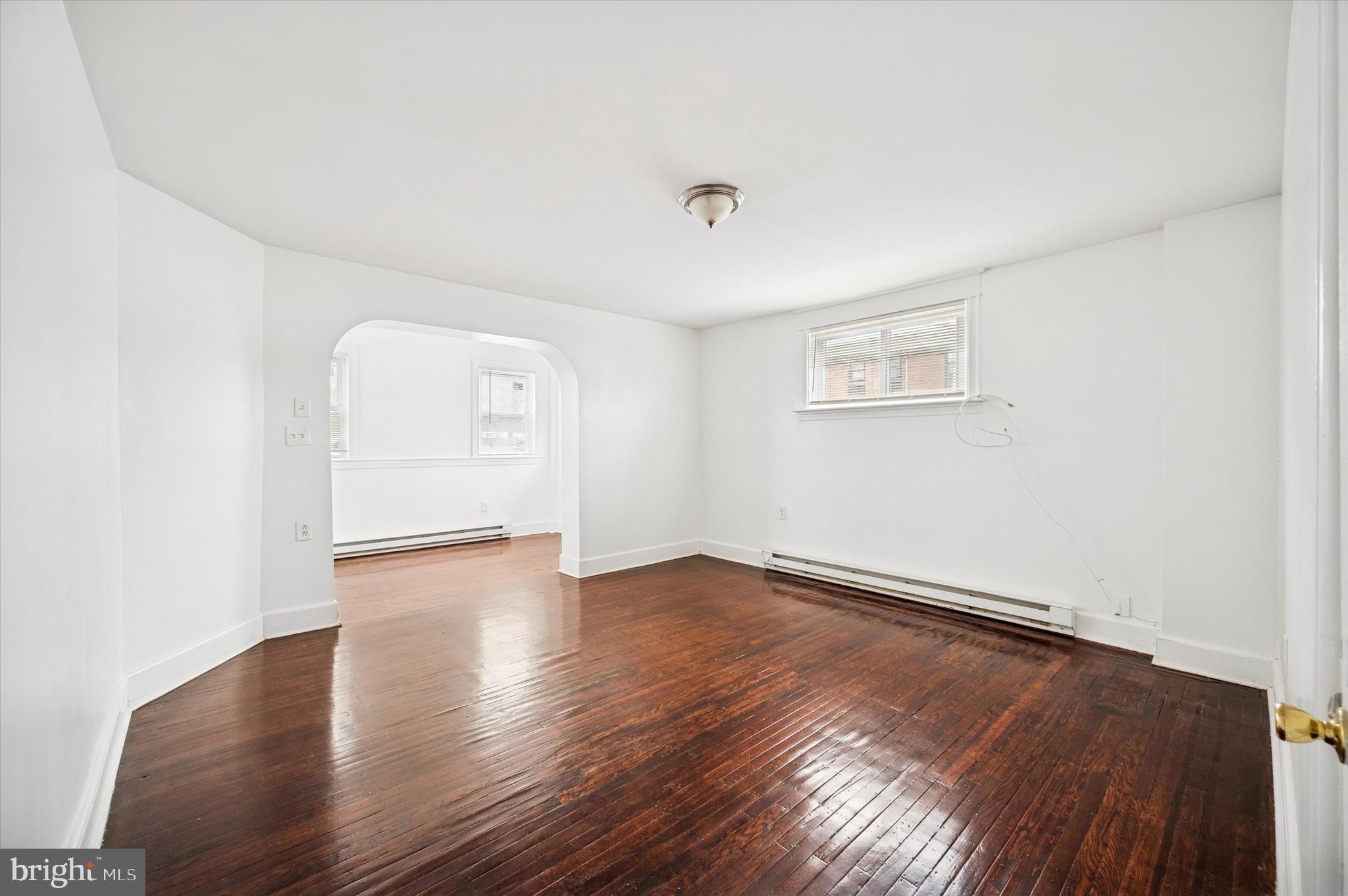 2000 Widener Place, Unit 2 Philadelphia, PA 19138 - Photo 5 of 15 an empty room with wooden floor and windows