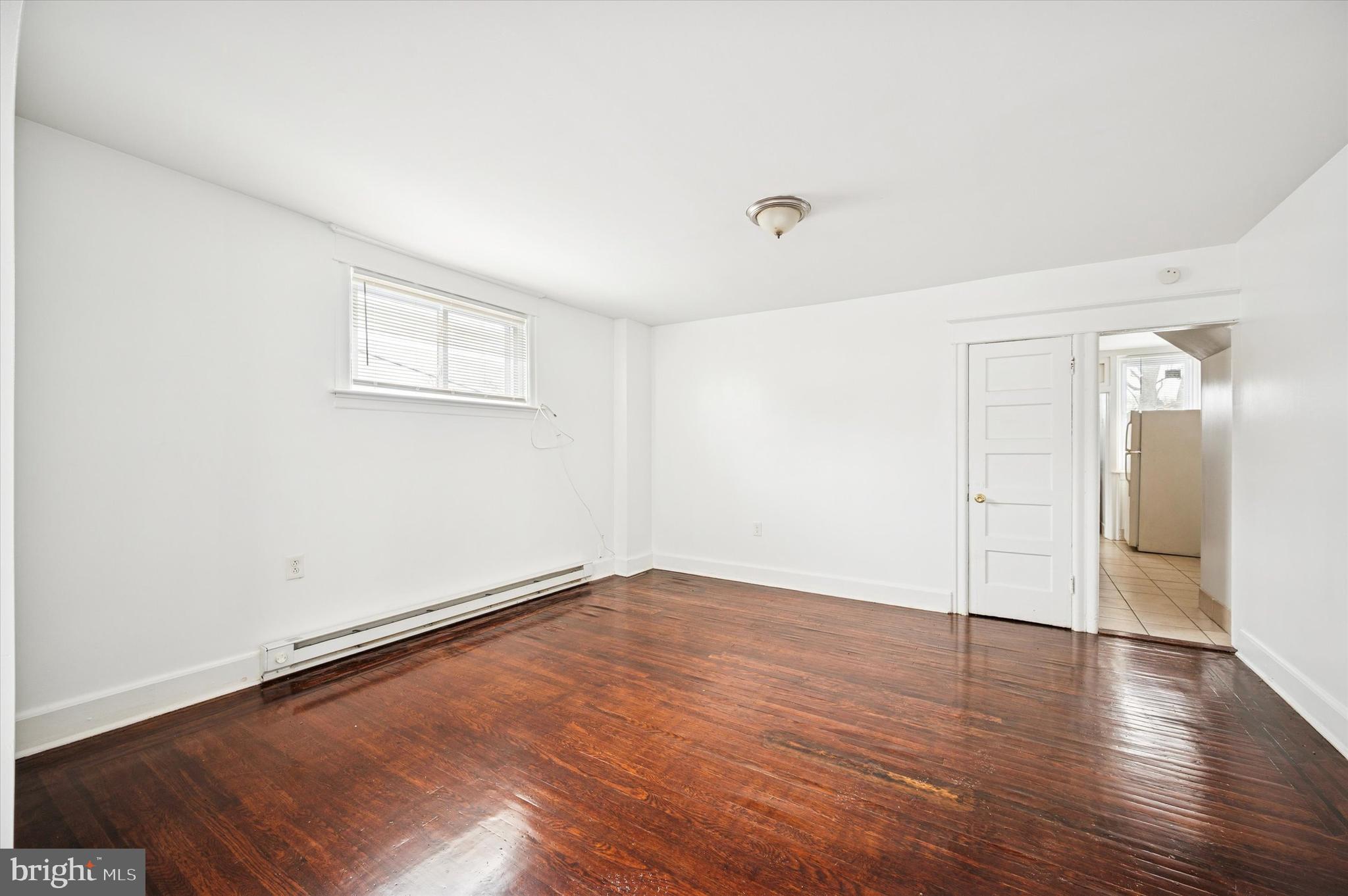 2000 Widener Place, Unit 2 Philadelphia, PA 19138 - Photo 6 of 15 an empty room with wooden floor and windows