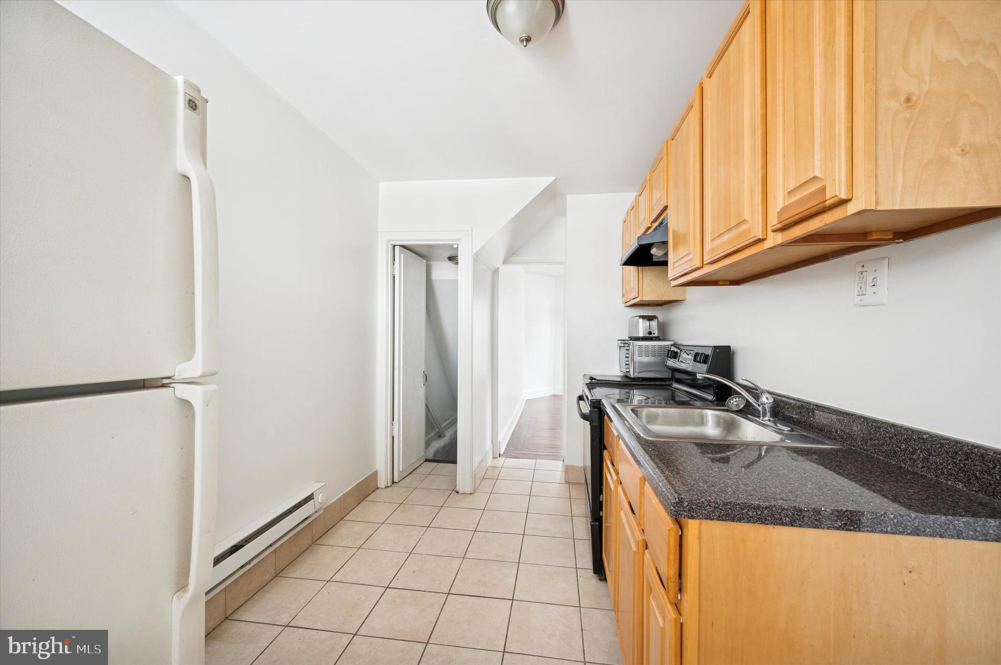 2000 Widener Place, Unit 2 Philadelphia, PA 19138 - Photo 7 of 15 a kitchen with stainless steel appliances granite countertop a sink a stove and a refrigerator