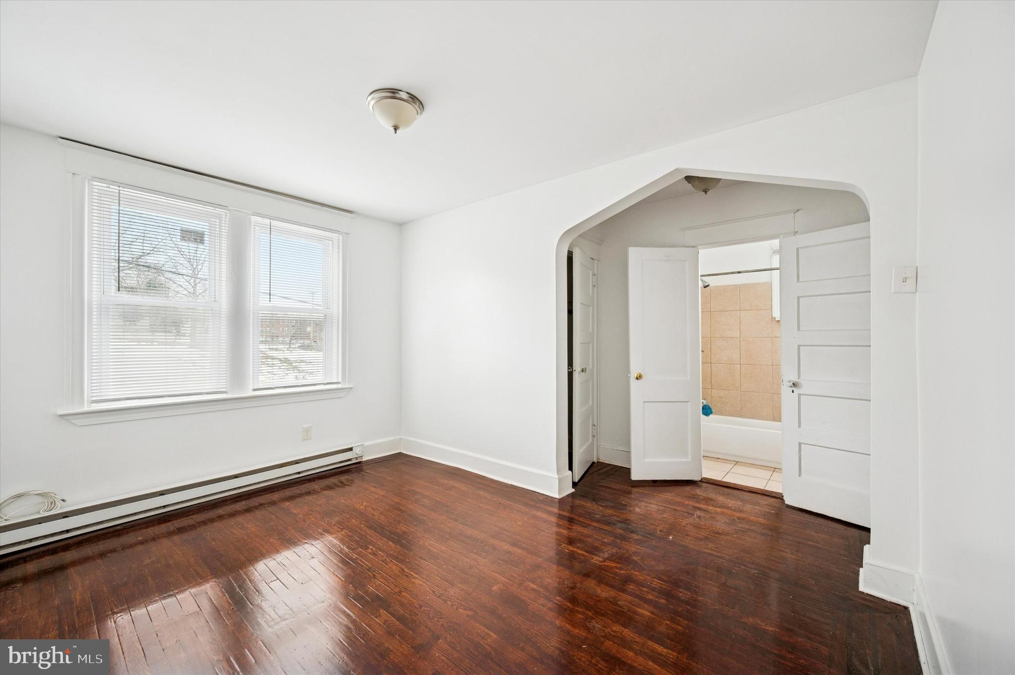 2000 Widener Place, Unit 2 Philadelphia, PA 19138 - Photo 9 of 15 an empty room with wooden floor and windows