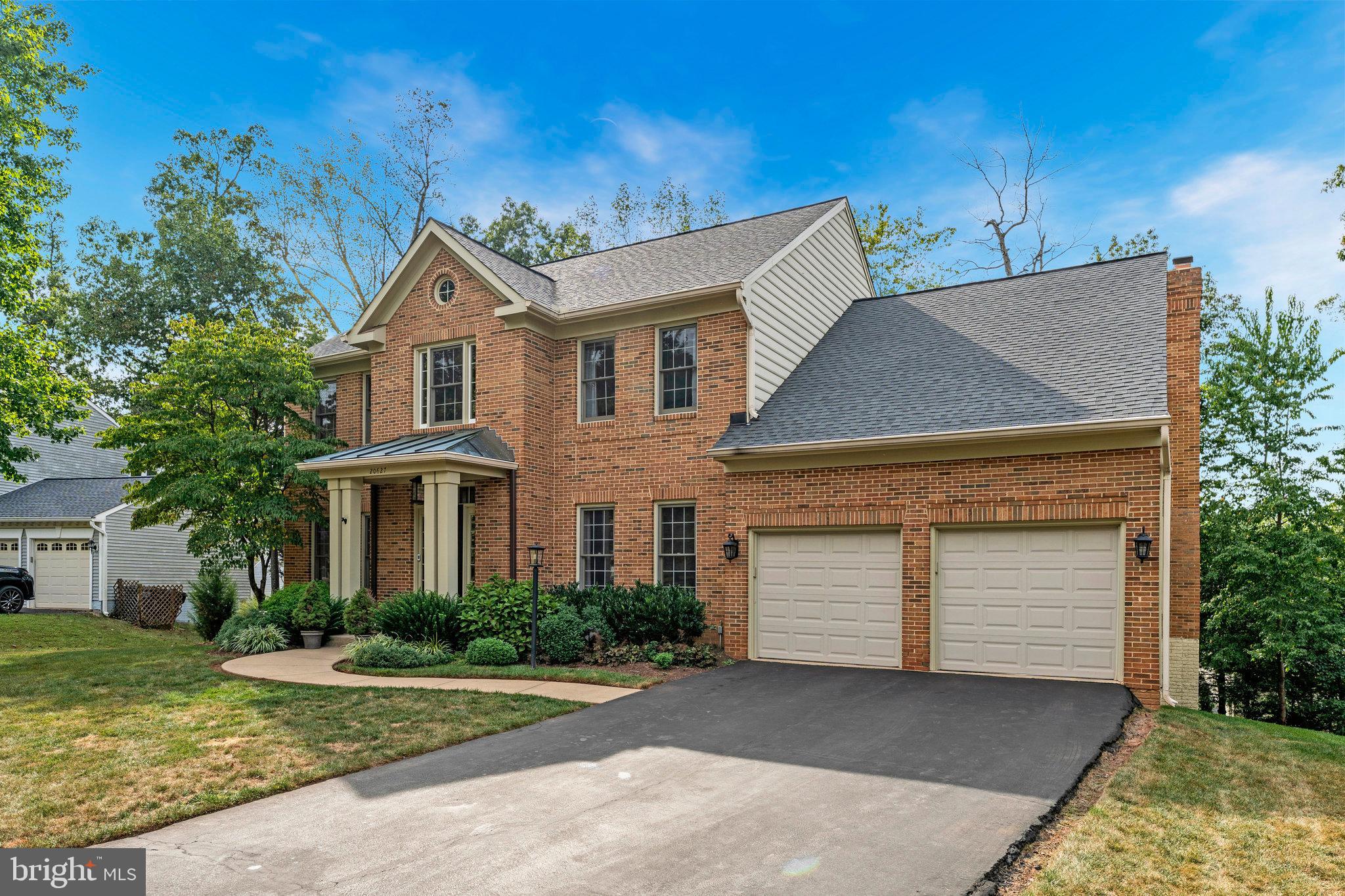 20627 Cutwater Place Sterling, VA 20165 - Photo 2 of 42 a front view of a house with a yard and garage