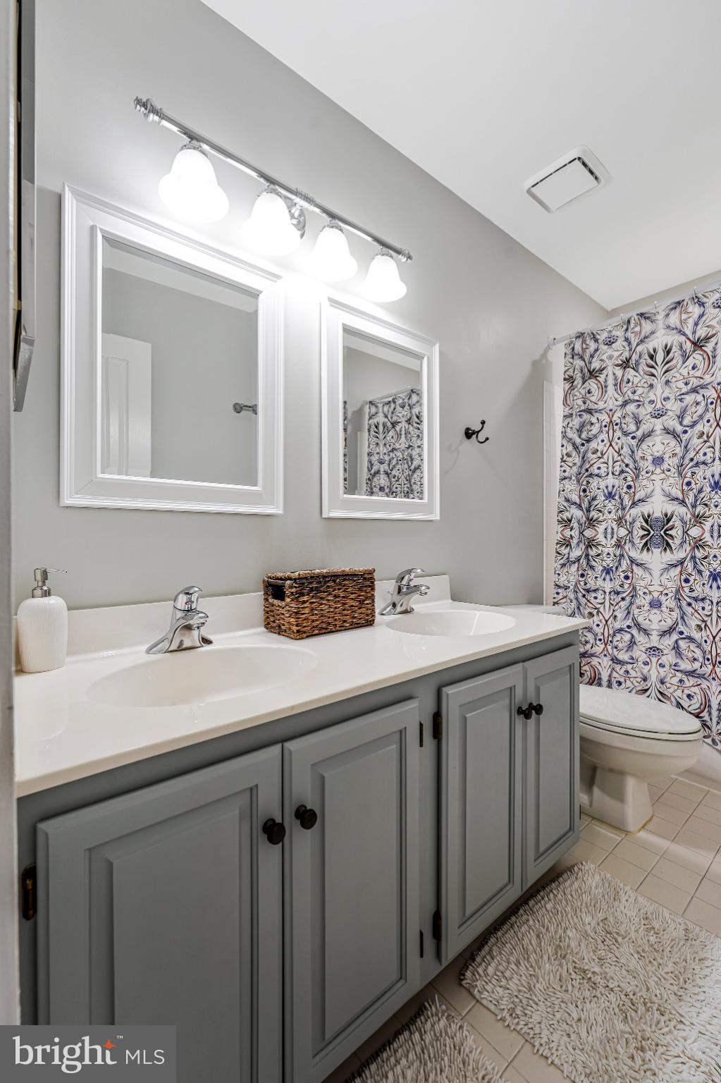 20627 Cutwater Place Sterling, VA 20165 - Photo 28 of 42 a bathroom with a double vanity sink and a mirror