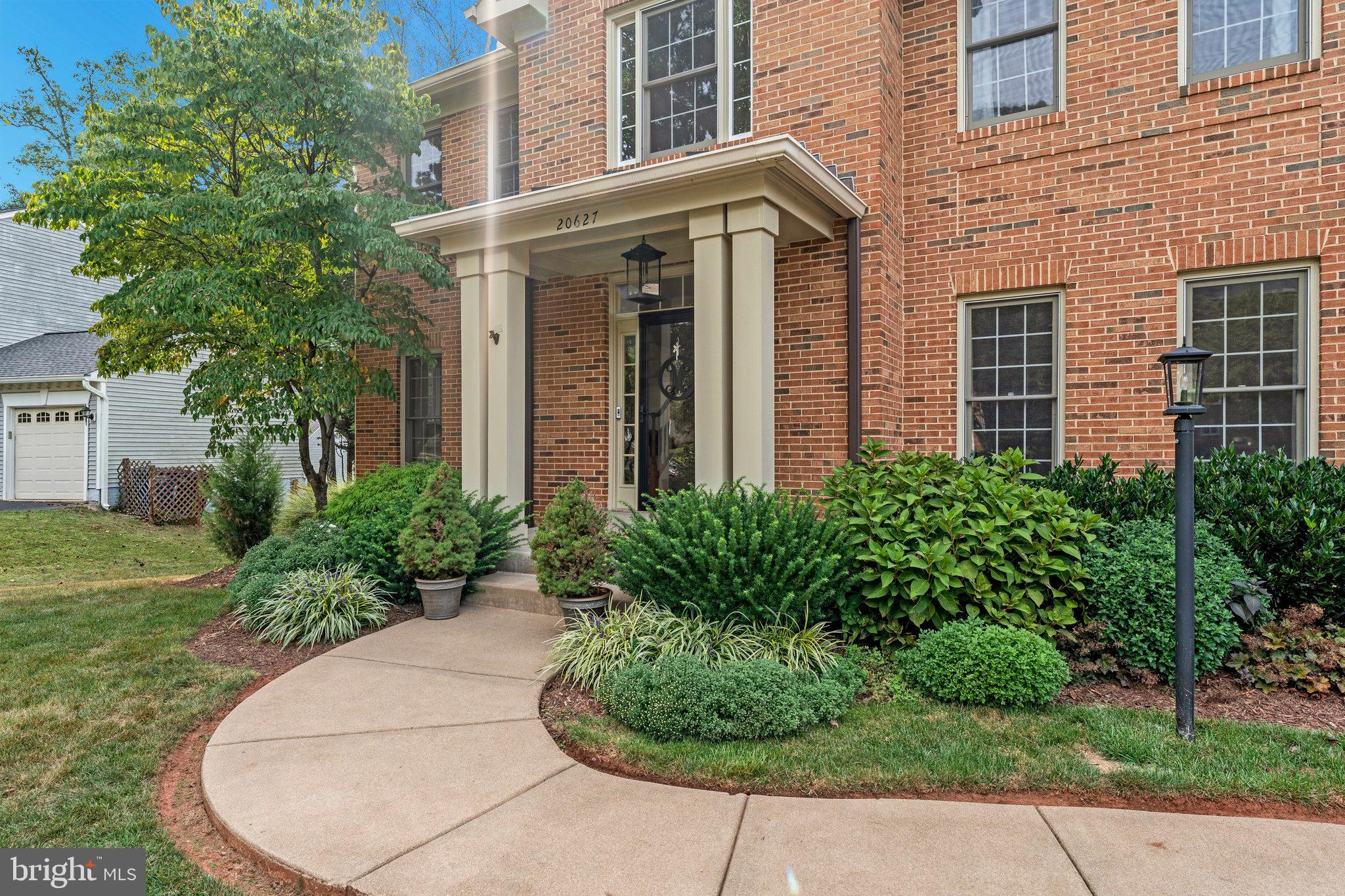 20627 Cutwater Place Sterling, VA 20165 - Photo 3 of 42 front view of a brick house with a yard