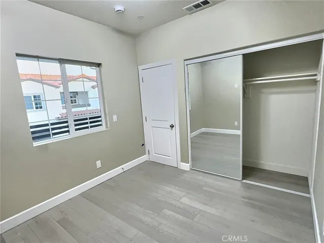 an empty room with windows and closet