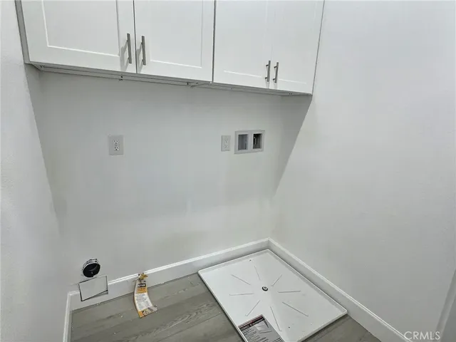 a view of a kitchen with white cabinets